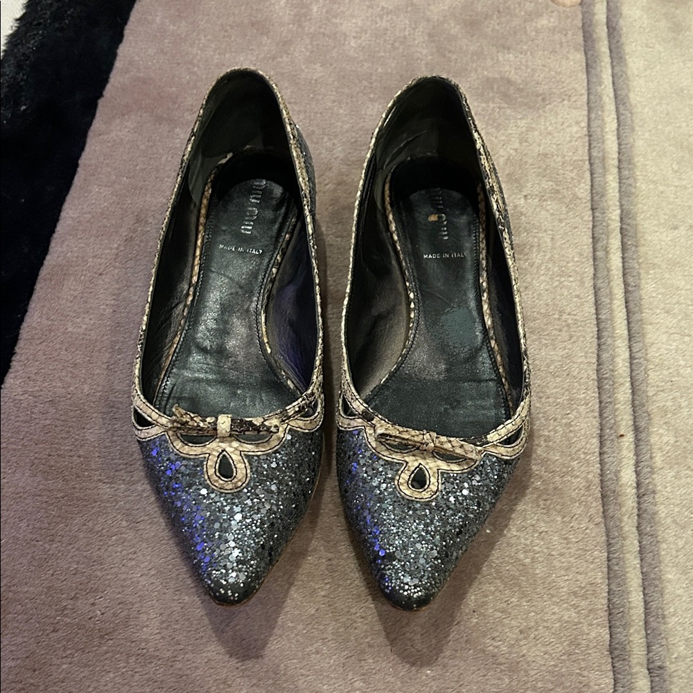 This is a pair of Miu Miu silver glitter pointed ballet flats.  Sz 39